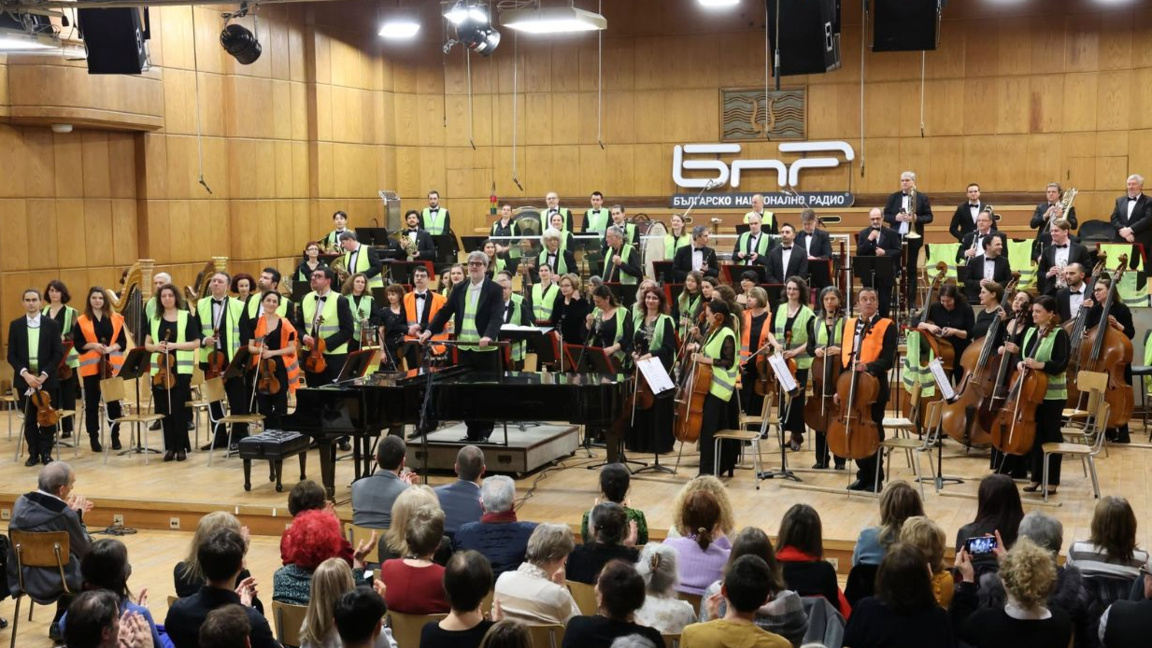 Symphony orchestra of the Bulgarian National Radio performing in Studio 1 of the BNR wearing reflective vests as sign of protest