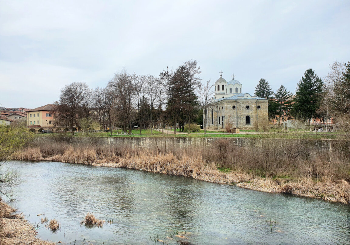 Zlatna Panega river, in the background St George the Great Martyr church in the town of Lukovit.
